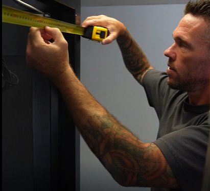 MIY team member measuring with a tape