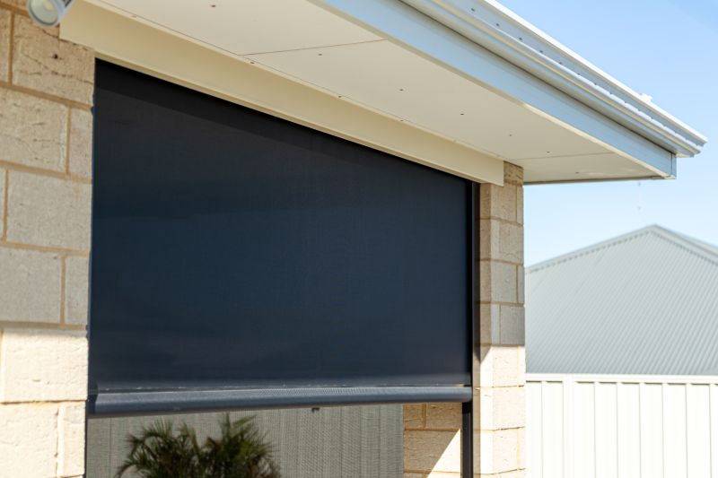 Front view of a dark Channel blind on a brick wall
